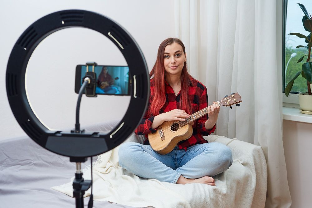 Young Woman Musician Records Video Broadcast on Phone
