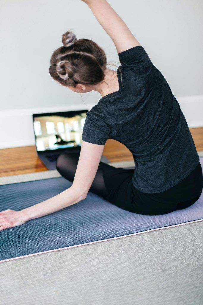 A Woman Is Exercising in Front of the Laptop