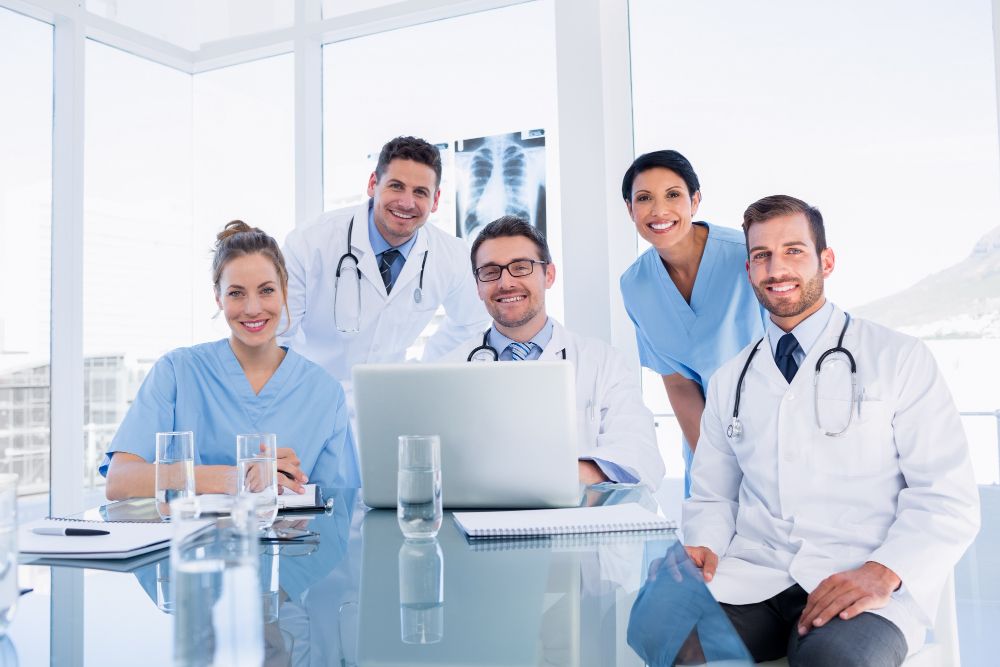 Happy Medical Team Using Laptop Together