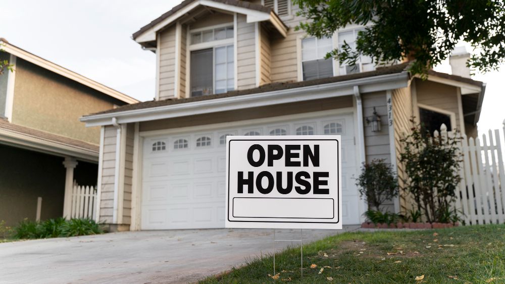 House with yard sign for open house
