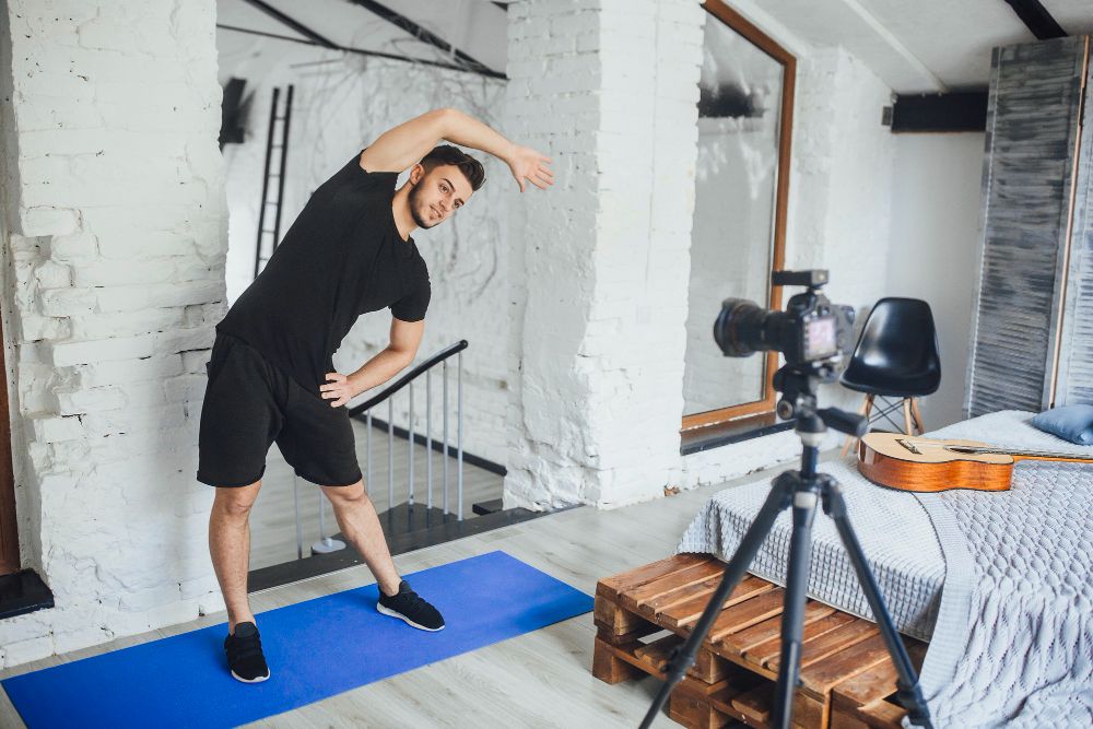 The Young, Beautiful Fitness Blogger Recording a Video for His Blog