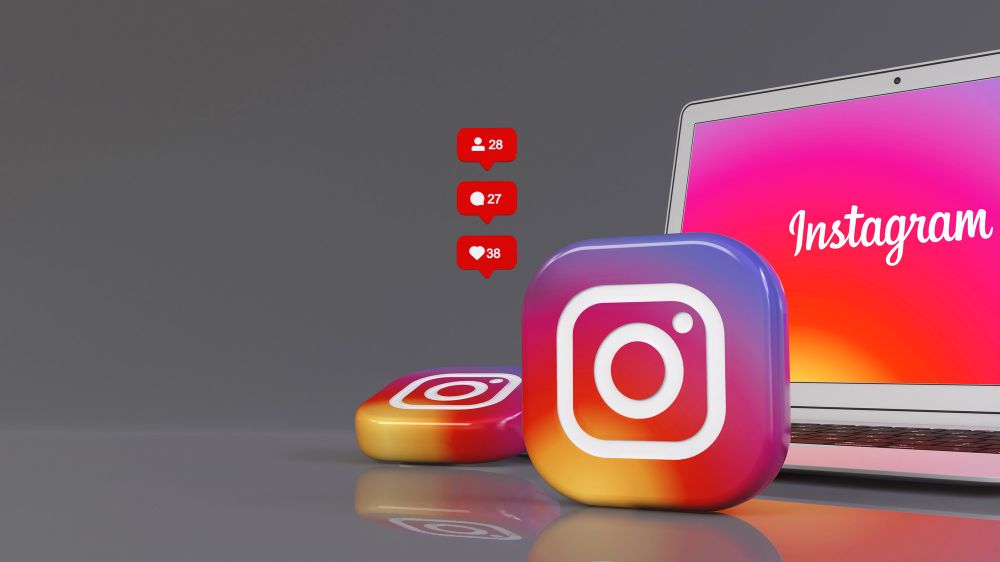 3D Rendering of Two Instagram Badges in Front of a Notebook With the App Logo on the Screen