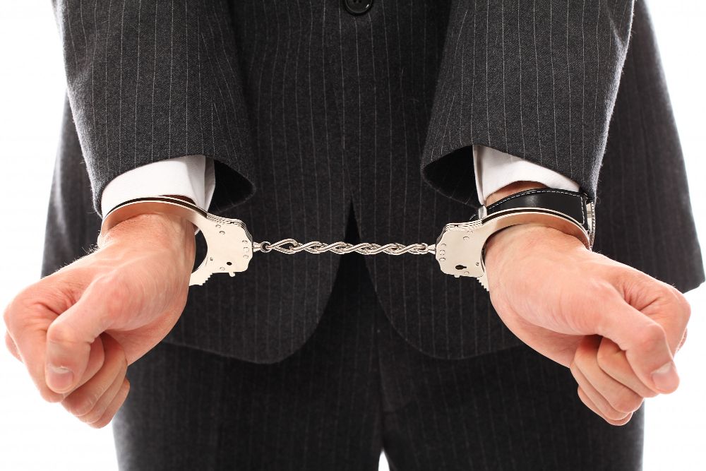 Hands of Young Man in Handcuffs
