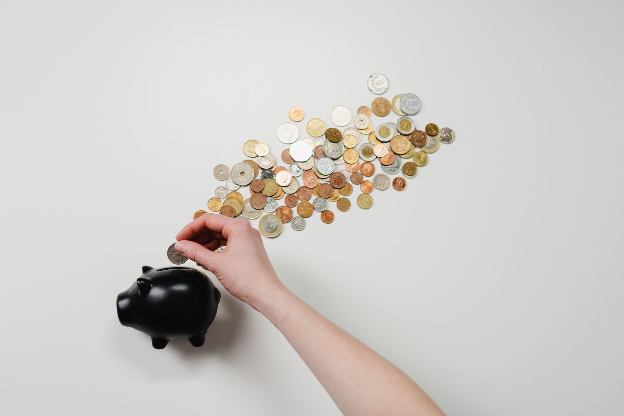 Piggy Bank and Coins on Gray Background
