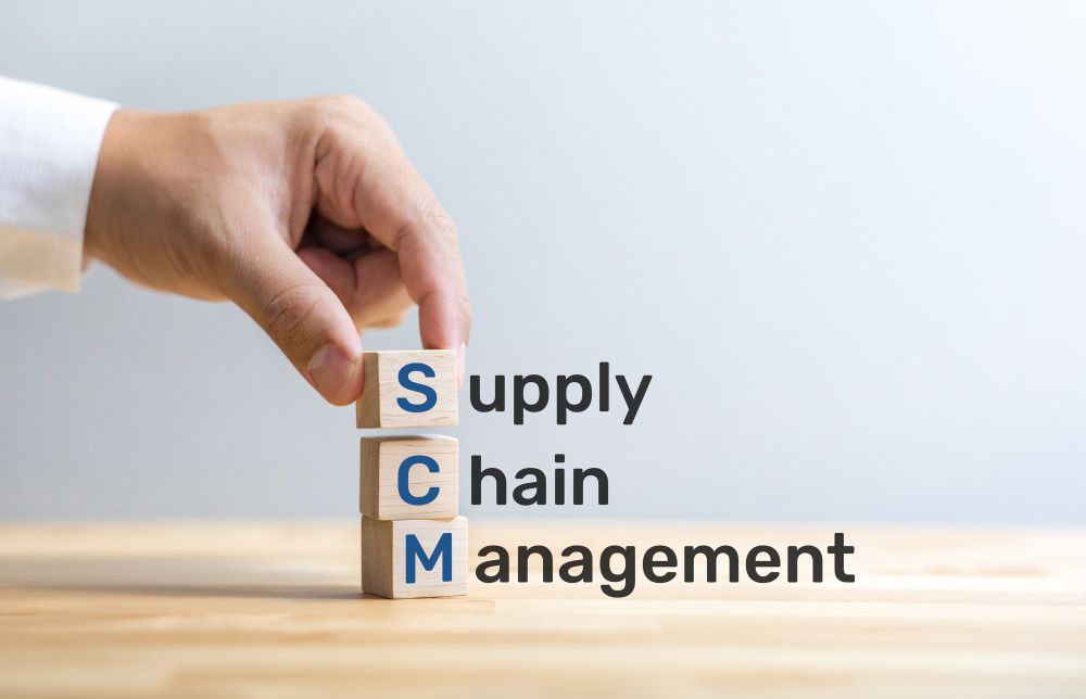 SCM Text on Wood Box With Male hand.business and Industry Management